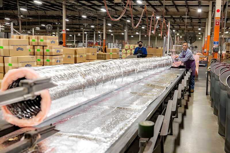 HVAC sheet metal products being inspected for quality control at MMF Inc manufacturing facility