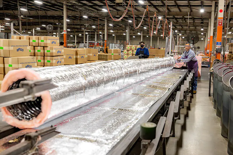 HVAC sheet metal products being inspected for quality control at MMF Inc manufacturing facility